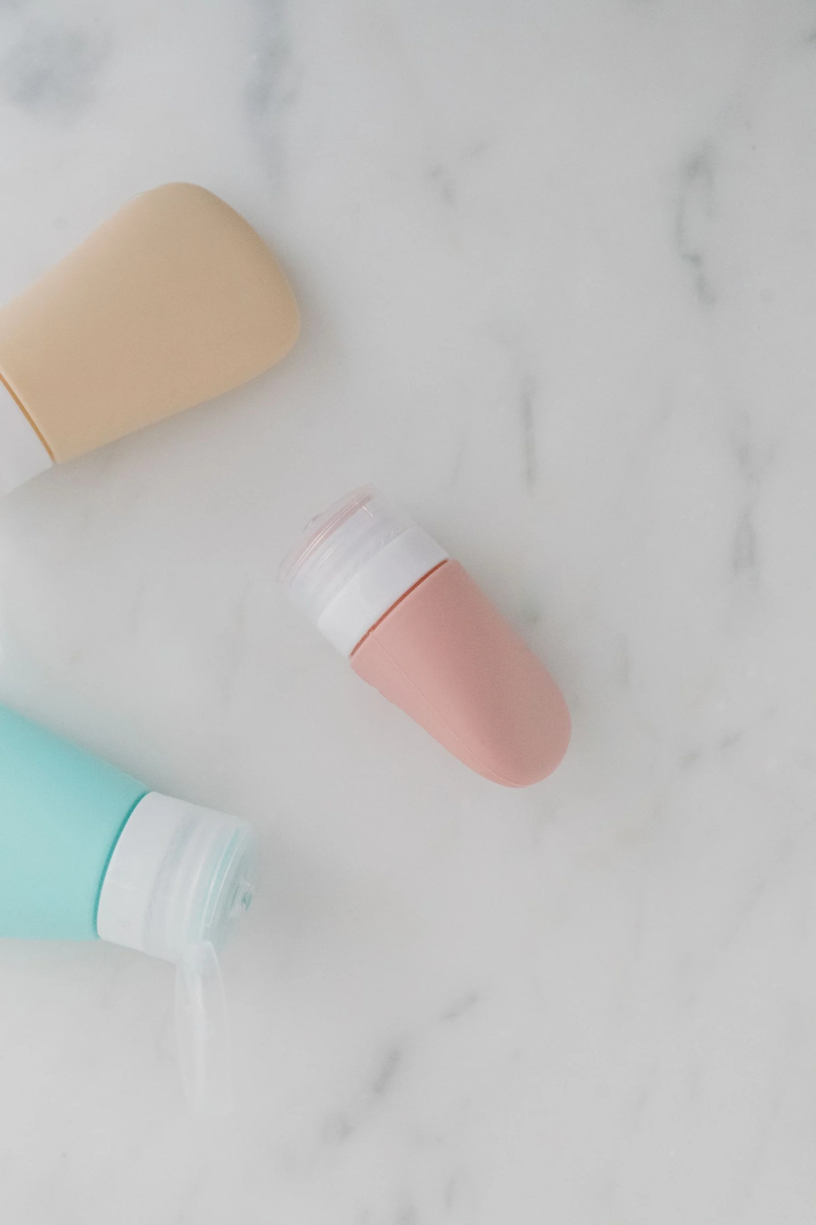 A flat lay of simple refillable personal care containers